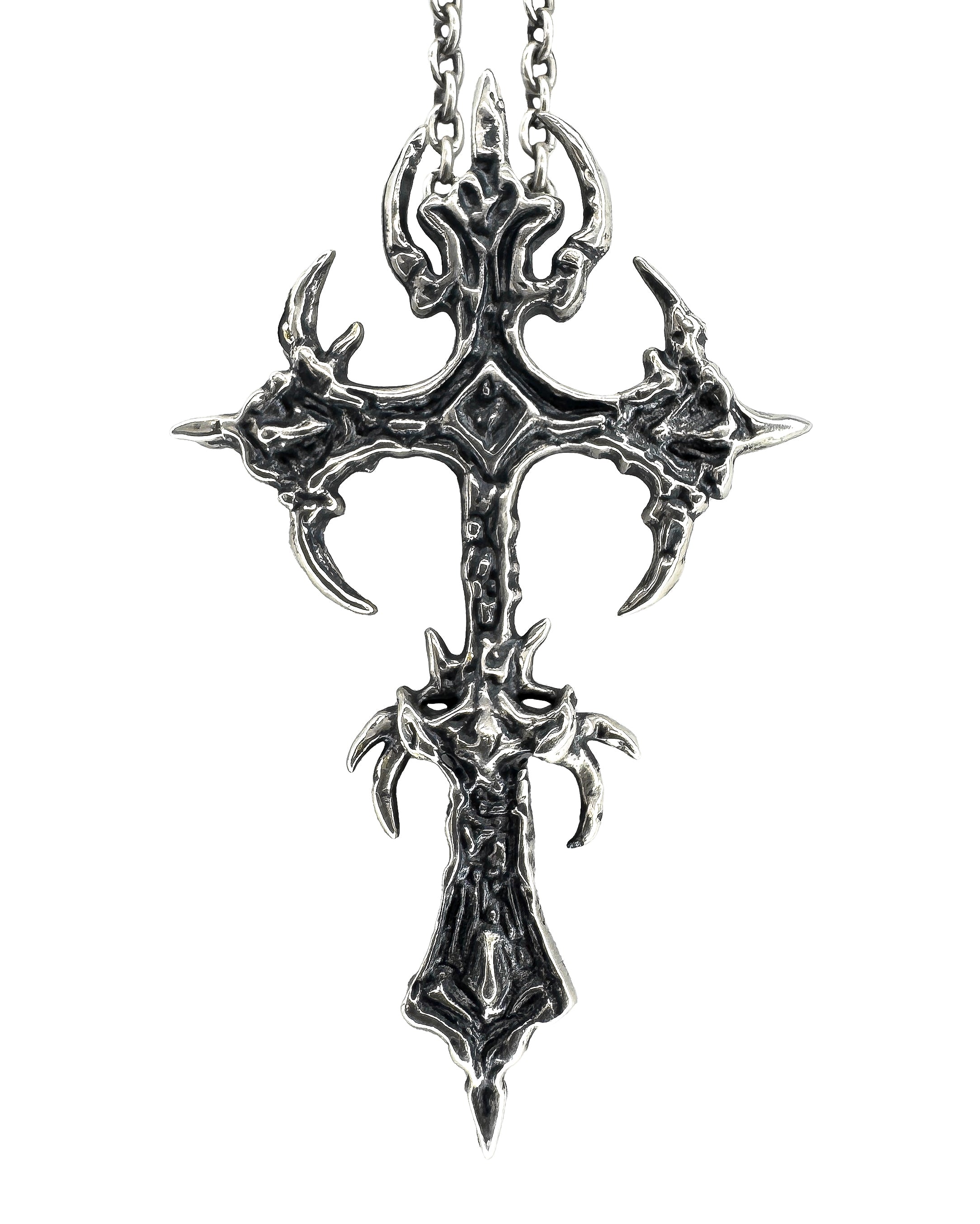 A sterling silver necklace with a intricate black and silver cross pendant.