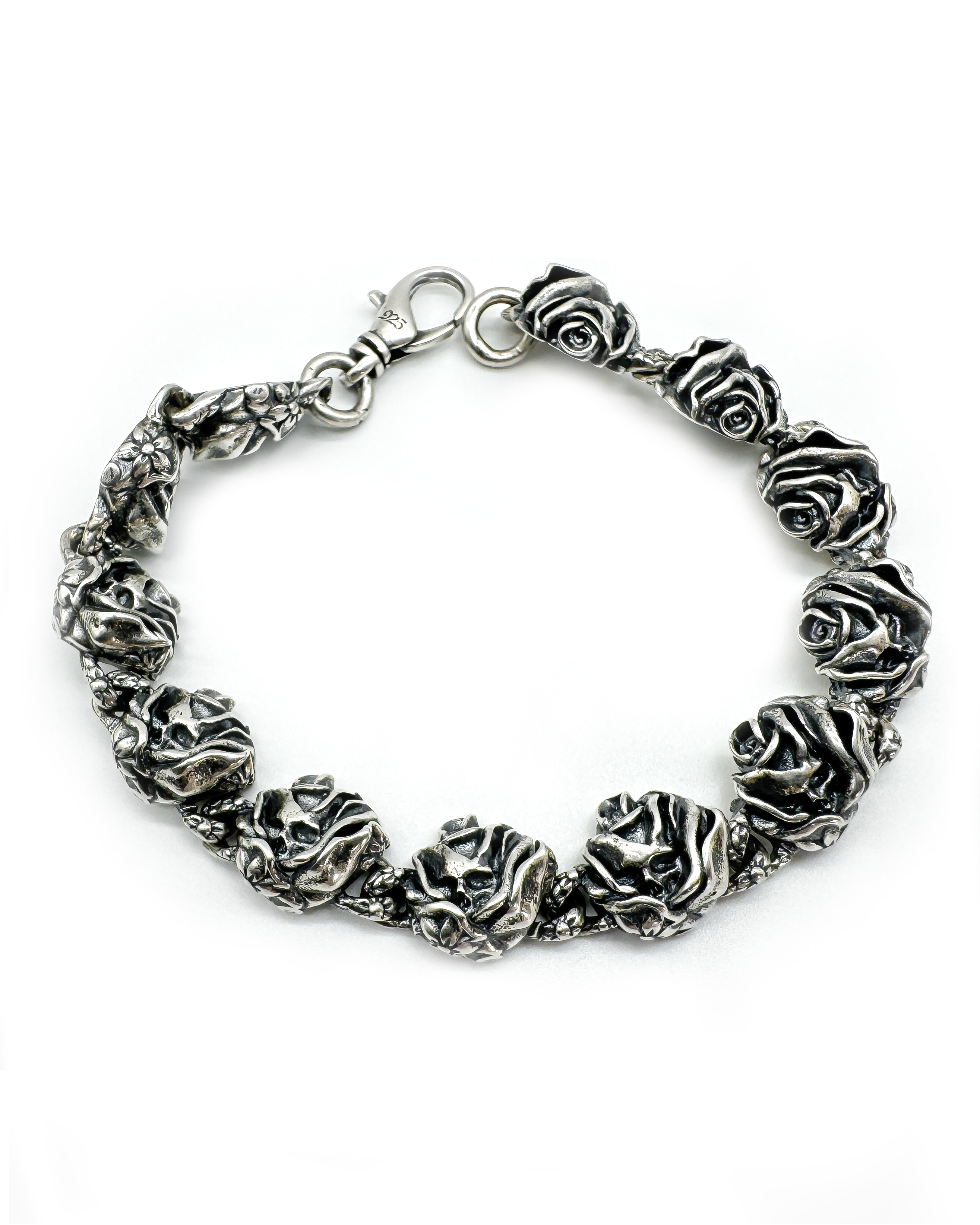 A bracelet made of silver or stainless steel with a series of skull and rose designs.