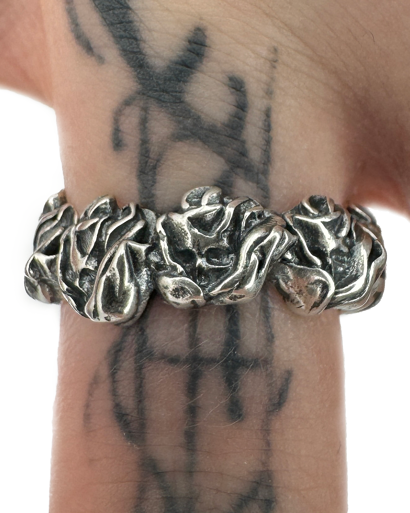 A sterling silver ring with a band designed to look like a rose on a males hand.