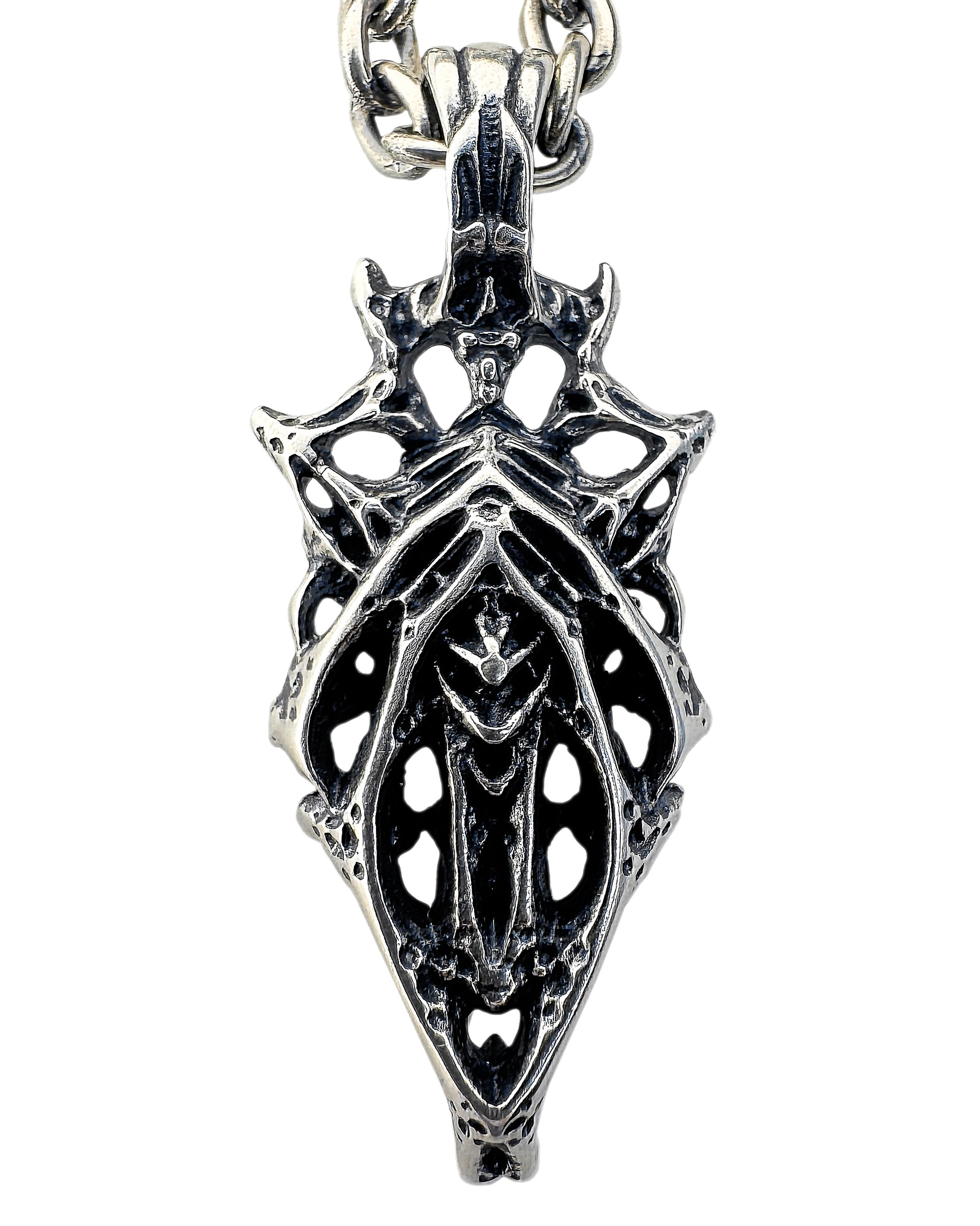 A sterling silver necklace with a geometric web-like pendant design featuring a symmetrical yet chaotic structure.