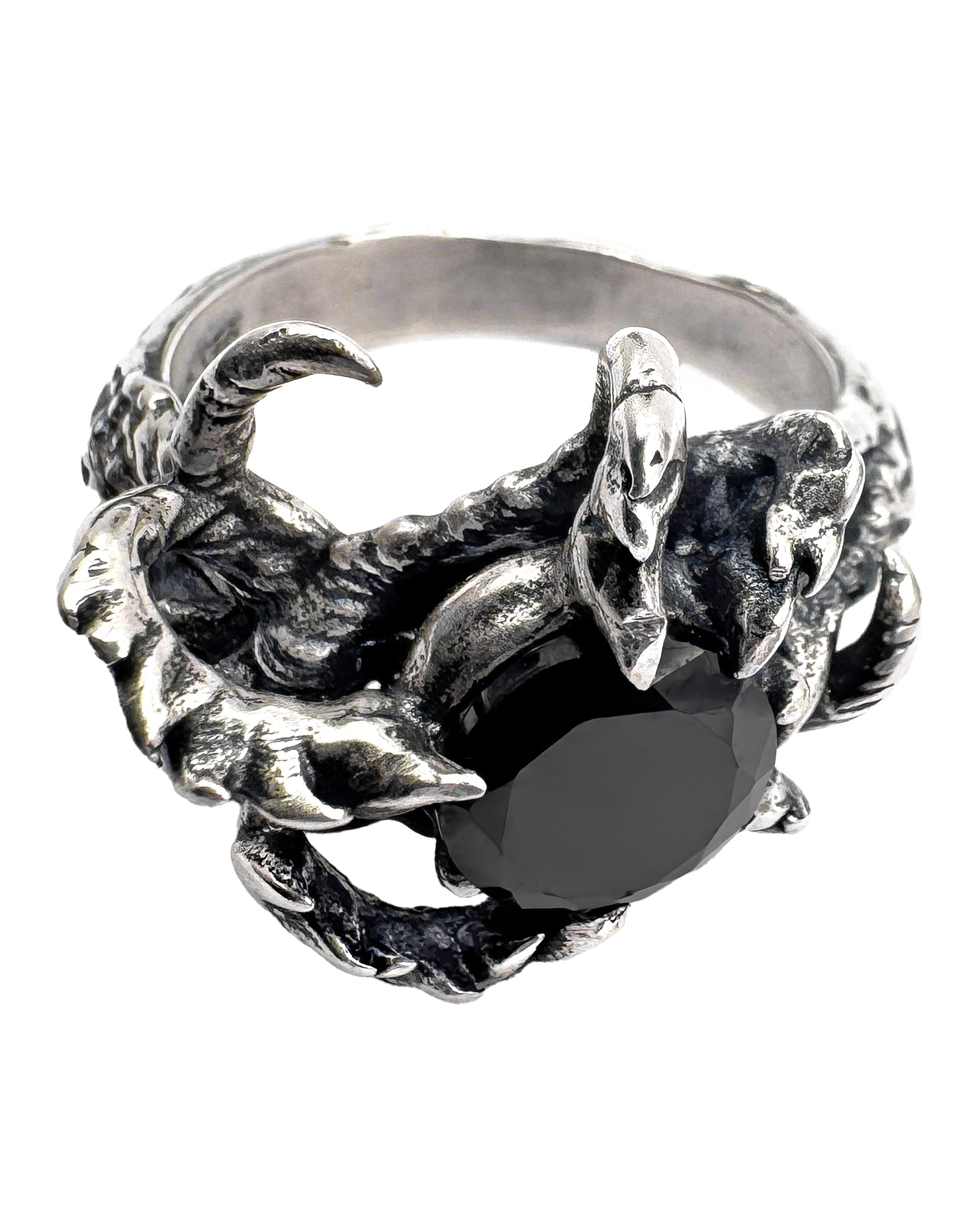 A sterling silver ring with a band designed as claw-like prongs holding a central onyx gemstone.
