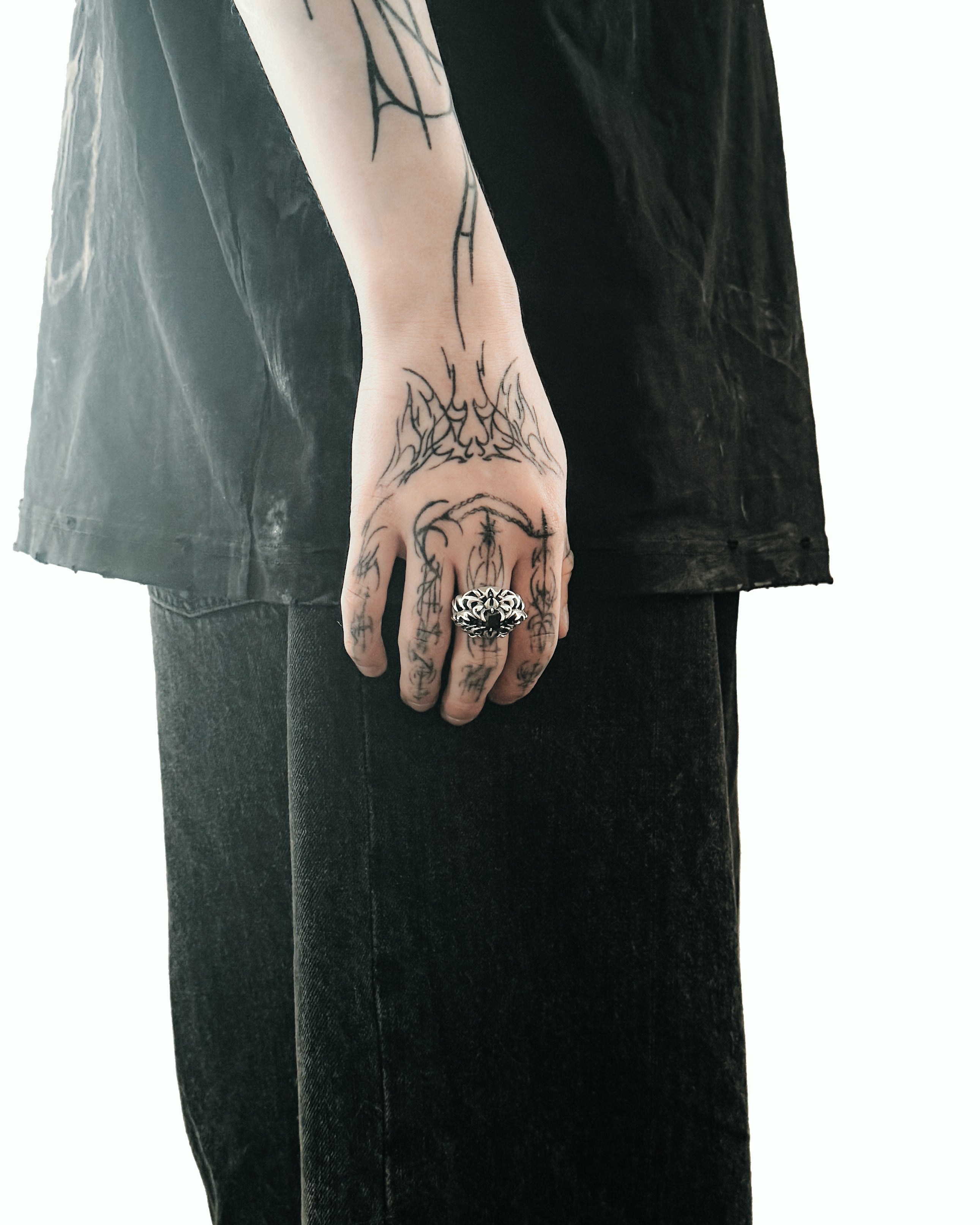 Gothic ring on hand, far away