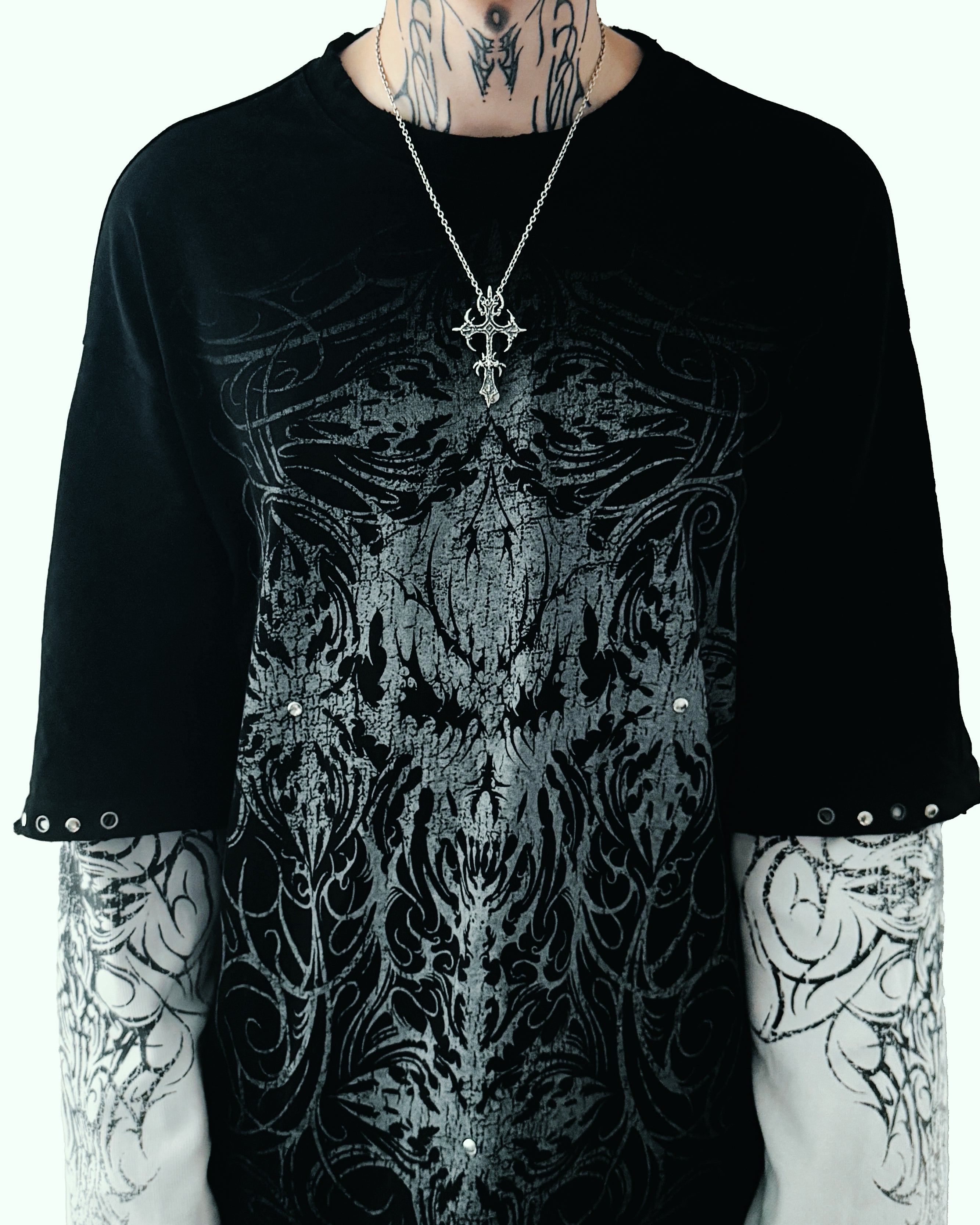 Sterling silver cross on male body, studio shot far away