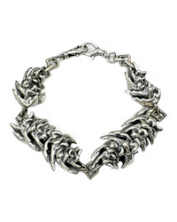 A chunky sterling silver bracelet with a geometric pattern featuring oversized vertebrae links.