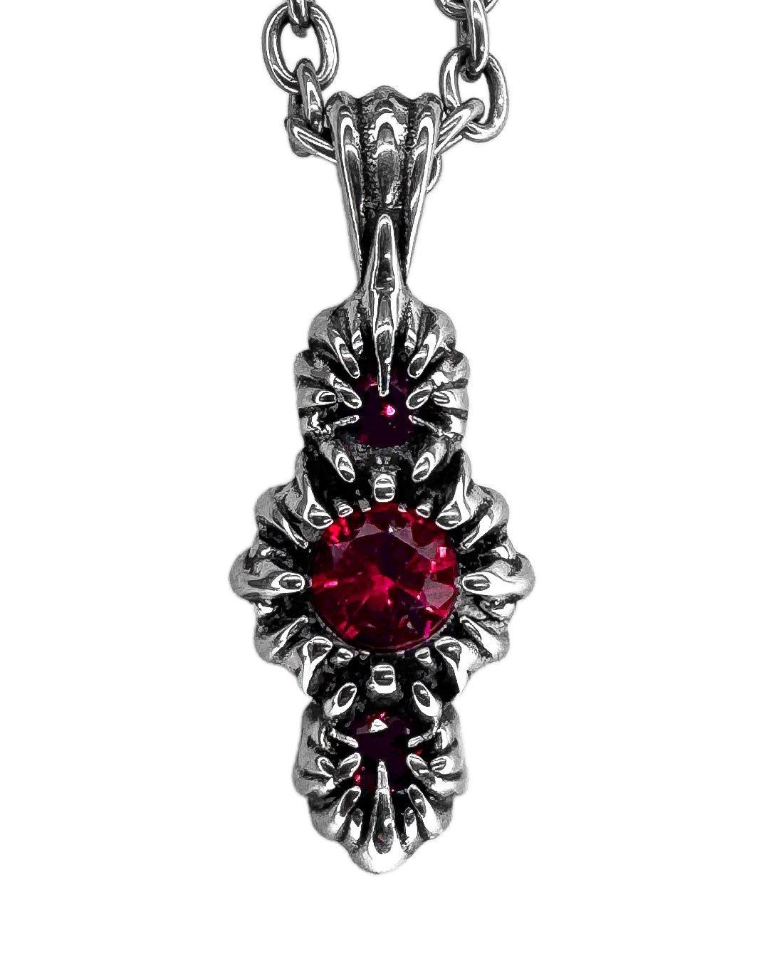 Silver pendant with a red gemstone on a white background
