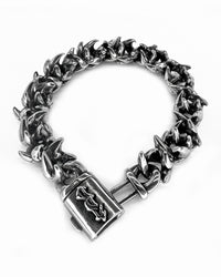 A bracelet with steel infinity links and a clasp, on a white background.