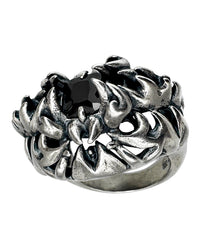 A sterling silver ring with a black gemstone and intricate engravings, designed in a gothic style.