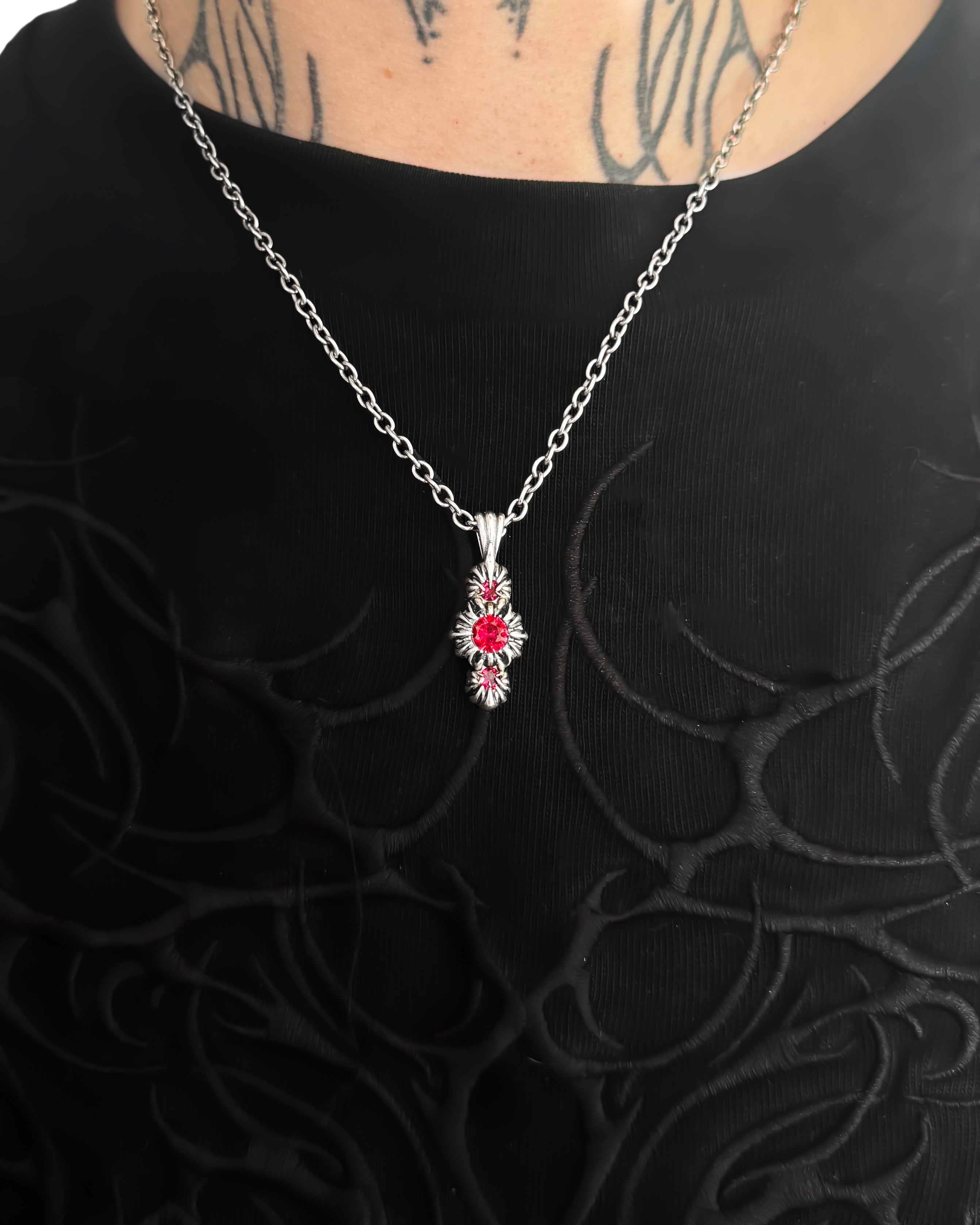Necklace with a floral pendant on a black textured background