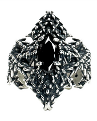 A sterling silver ring with a trident-shaped design, featuring a central black gemstone and intricate textures around the band.